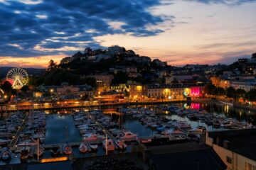 aerial view of the harbor and illuminated buildings of torquay at sunset devon england