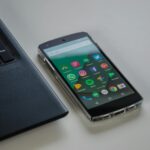 black android smartphone near laptop