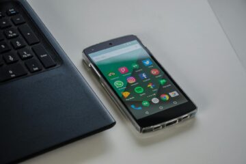 black android smartphone near laptop