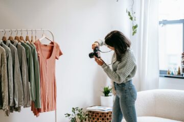 woman taking photo of clothes